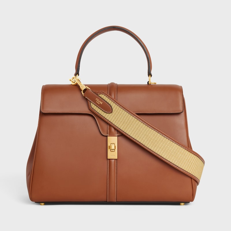 strap in raffia effect textile and calfskin with gold finishing